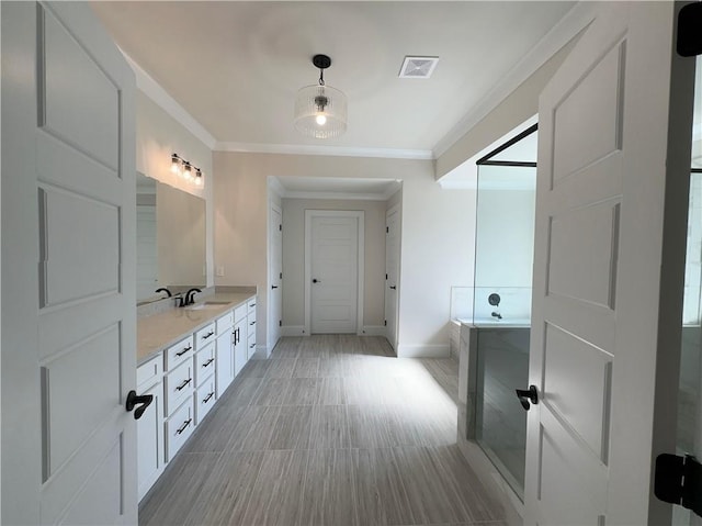 bathroom featuring a tub to relax in, crown molding, and vanity