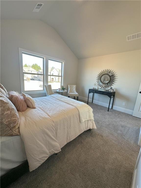 bedroom with carpet floors and lofted ceiling