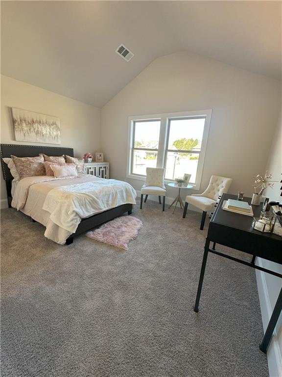 carpeted bedroom with vaulted ceiling