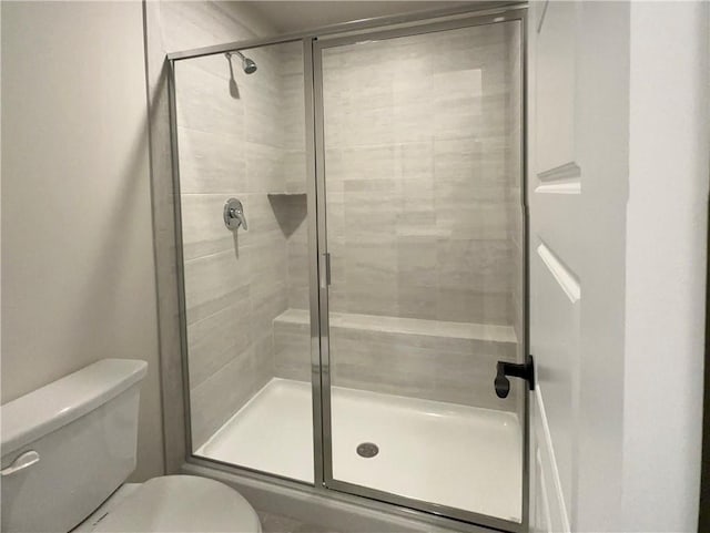 bathroom with toilet and walk in shower