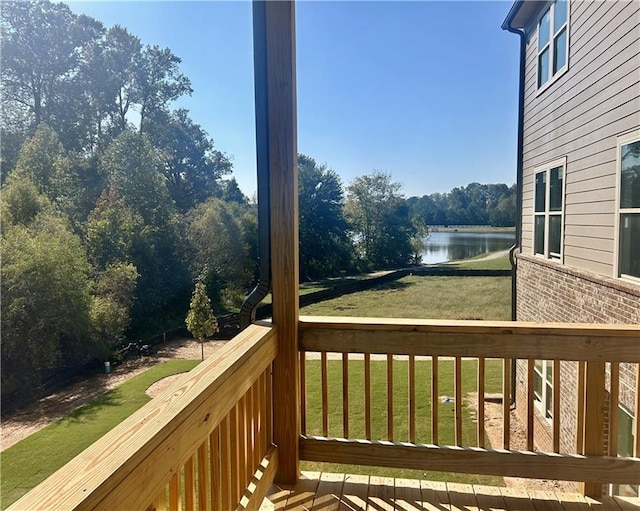 deck featuring a water view and a yard