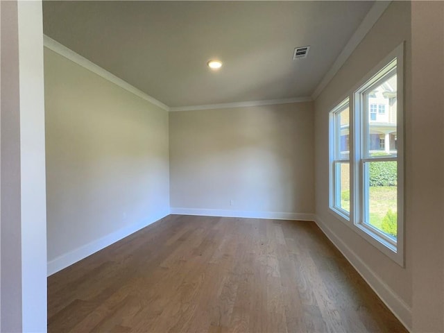 spare room with dark hardwood / wood-style floors and ornamental molding