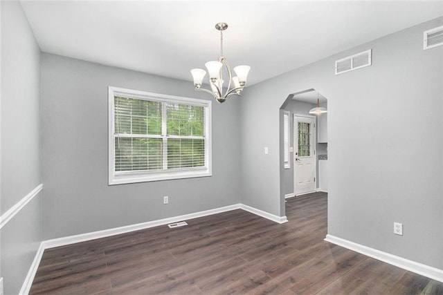 2722 Spring Side Ct, Douglasville, GA 30135 - unfurnished room featuring arched walkways, a chandelier, dark wood finished floors, and baseboards