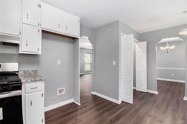 2722 Spring Side Ct, Douglasville, GA 30135 - kitchen with stainless steel range with gas stovetop, range hood, a chandelier, and dark wood finished floors