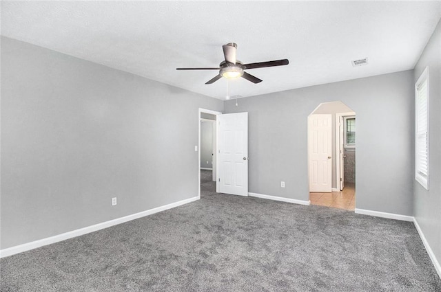 2722 Spring Side Ct, Douglasville, GA 30135 - unfurnished bedroom featuring carpet, baseboards, arched walkways, and ceiling fan