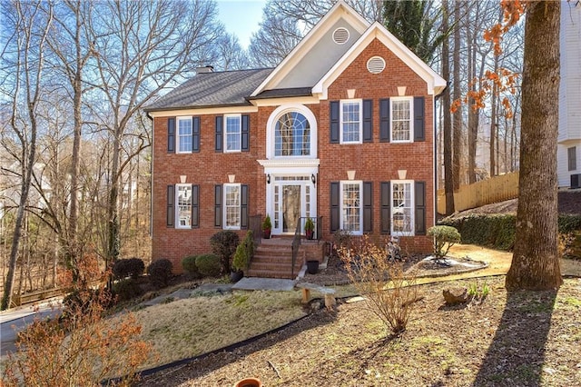 view of front of property with brick siding and a chimney