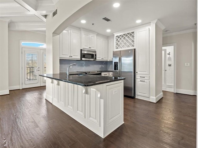 kitchen featuring stainless steel appliances, white cabinetry, dark hardwood / wood-style floors, and a breakfast bar area