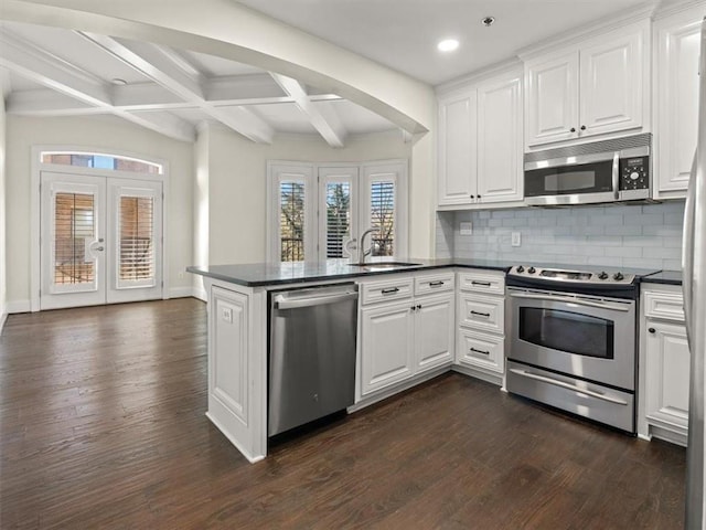 kitchen featuring white cabinetry, french doors, kitchen peninsula, and appliances with stainless steel finishes