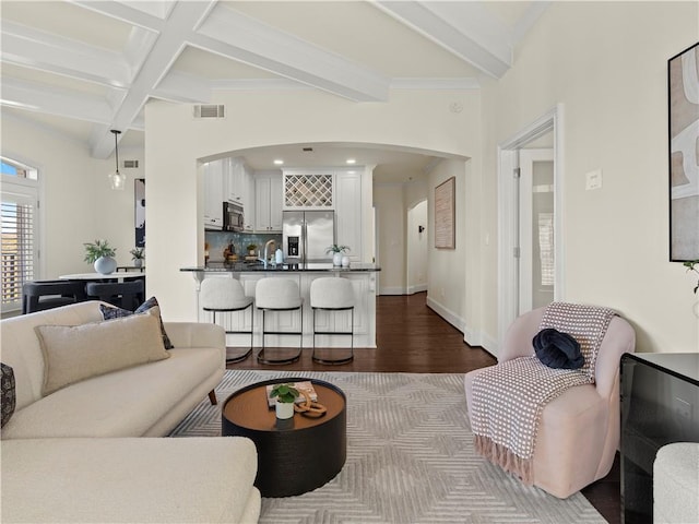 living room featuring coffered ceiling, sink, beam ceiling, and hardwood / wood-style flooring