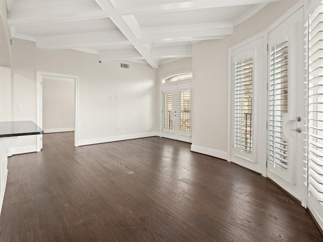 unfurnished living room with beam ceiling, dark hardwood / wood-style floors, coffered ceiling, and french doors