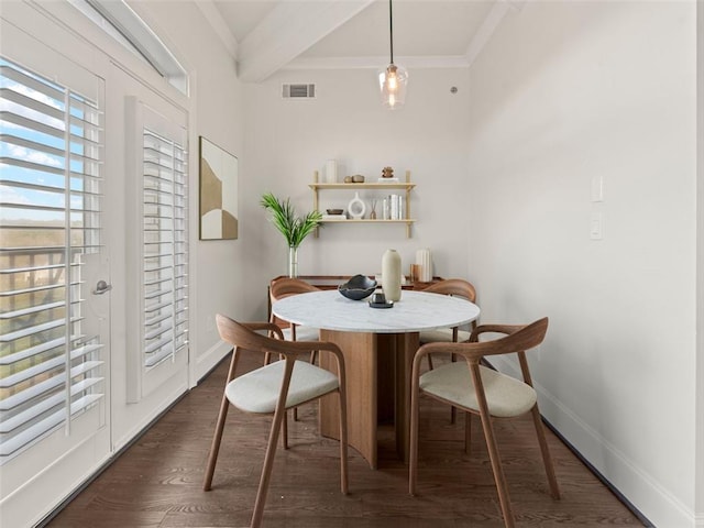 dining room featuring dark hardwood / wood-style flooring, beam ceiling, and ornamental molding