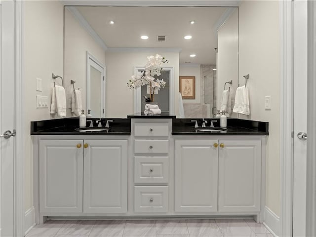 bathroom featuring vanity, crown molding, and walk in shower