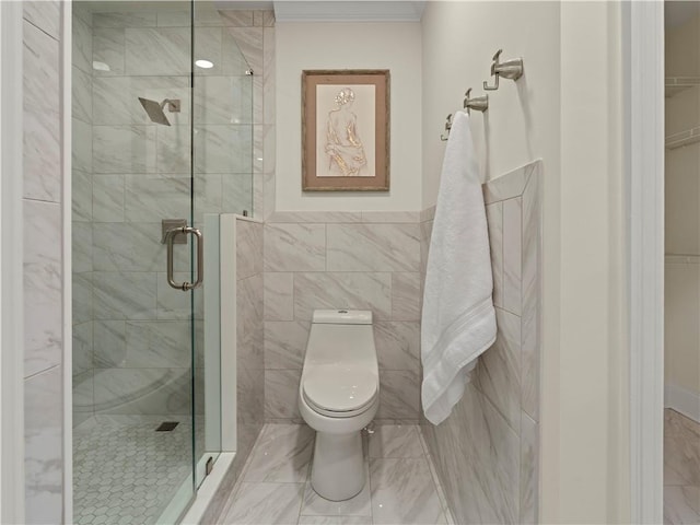 bathroom featuring toilet, a shower with shower door, and tile walls