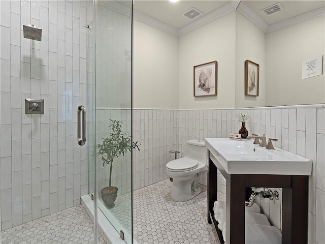 bathroom with toilet, a shower with shower door, sink, crown molding, and tile walls