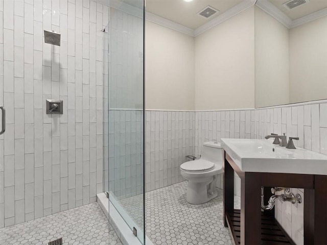 bathroom with crown molding, tile patterned floors, toilet, and a shower with door