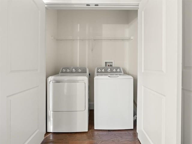 washroom with dark hardwood / wood-style flooring and washer and dryer