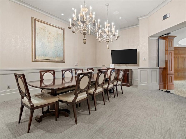 dining room with light colored carpet, ornamental molding, and ornate columns