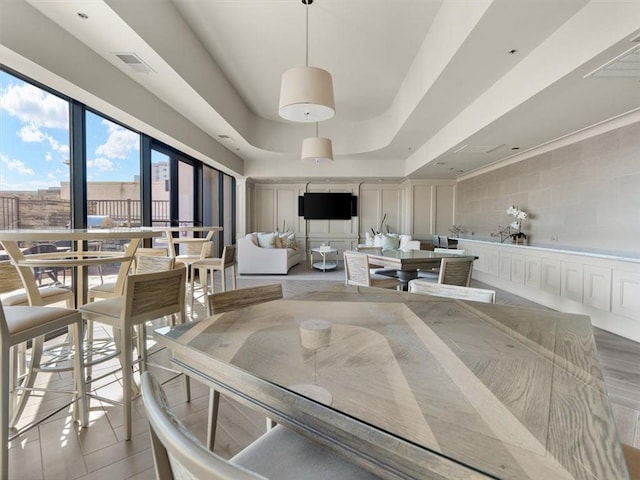 dining space featuring a tray ceiling