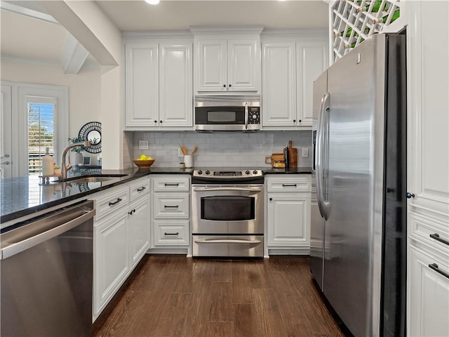 kitchen featuring white cabinetry, appliances with stainless steel finishes, dark hardwood / wood-style flooring, and sink