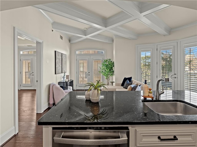 kitchen with french doors, coffered ceiling, sink, dark stone counters, and white cabinets