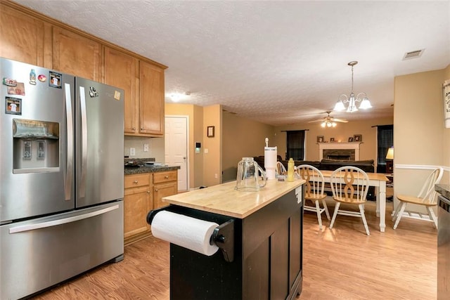 3265 Watson Gate Rd, Loganville, GA 30052 - kitchen featuring stainless steel fridge with ice dispenser, butcher block countertops, light wood-style floors, a chandelier, and pendant lighting
