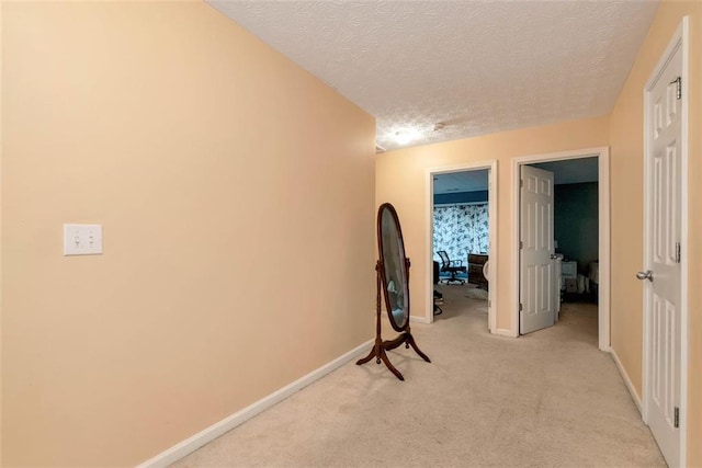 3265 Watson Gate Rd, Loganville, GA 30052 - hall with a textured ceiling, light colored carpet, and baseboards