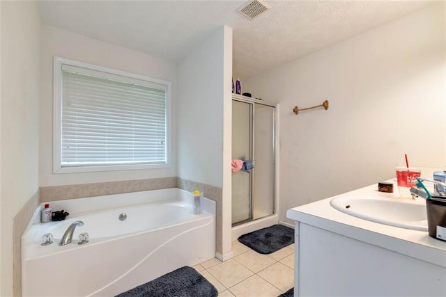 3265 Watson Gate Rd, Loganville, GA 30052 - full bathroom featuring tile patterned floors, a stall shower, a garden tub, and vanity