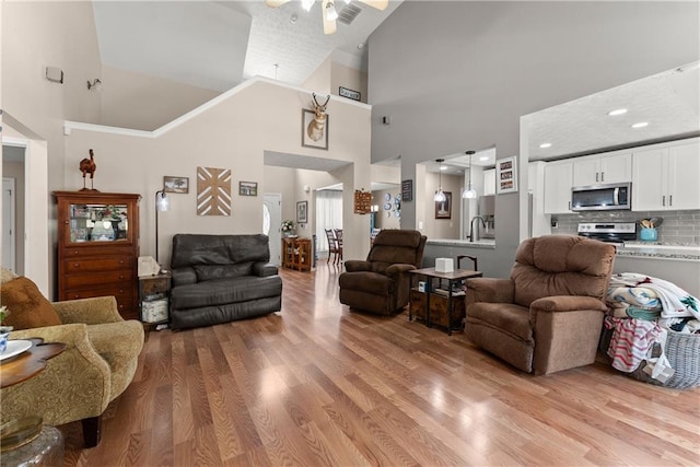 69 Maple Leaf Ct, Hoschton, GA 30548 - living area featuring high vaulted ceiling, light wood-style flooring, and a ceiling fan