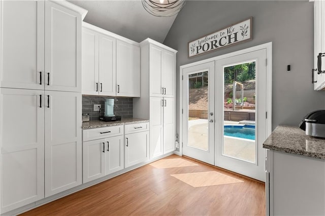 69 Maple Leaf Ct, Hoschton, GA 30548 - doorway with french doors, light wood finished floors, and lofted ceiling