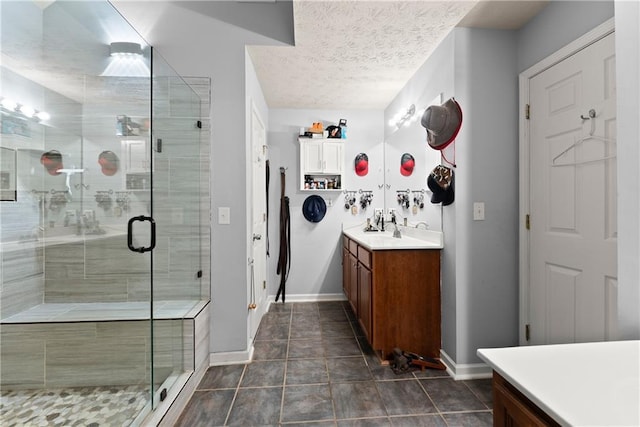 69 Maple Leaf Ct, Hoschton, GA 30548 - bathroom with vanity, a shower stall, and a textured ceiling
