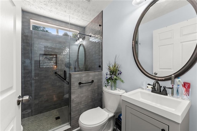 69 Maple Leaf Ct, Hoschton, GA 30548 - bathroom featuring vanity, a stall shower, and a textured ceiling