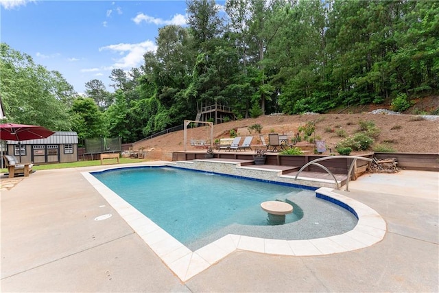 69 Maple Leaf Ct, Hoschton, GA 30548 - view of swimming pool featuring a trampoline, a patio area, a storage shed, and view of scattered trees