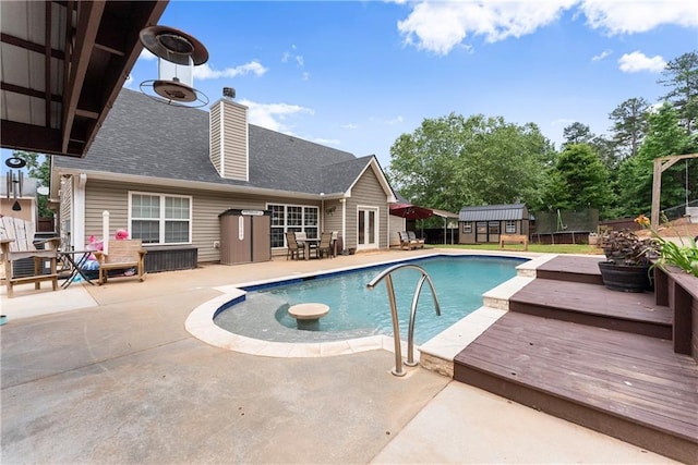 69 Maple Leaf Ct, Hoschton, GA 30548 - view of swimming pool featuring a shed, a patio area, and a wooden deck