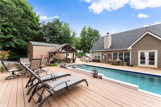 69 Maple Leaf Ct, Hoschton, GA 30548 - swimming pool with outdoor dining area, a wooden deck, and french doors