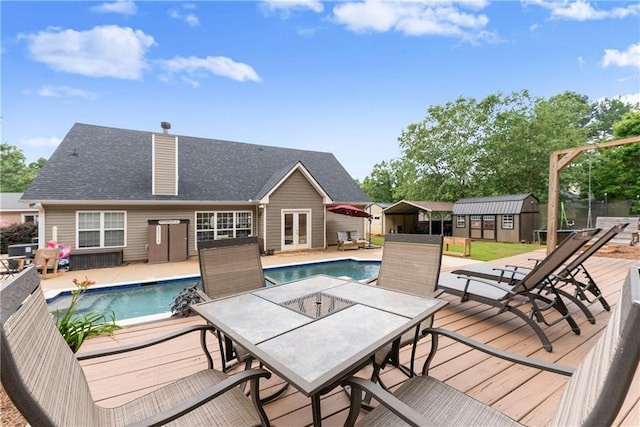 69 Maple Leaf Ct, Hoschton, GA 30548 - view of pool with french doors, outdoor dining area, a shed, and a deck