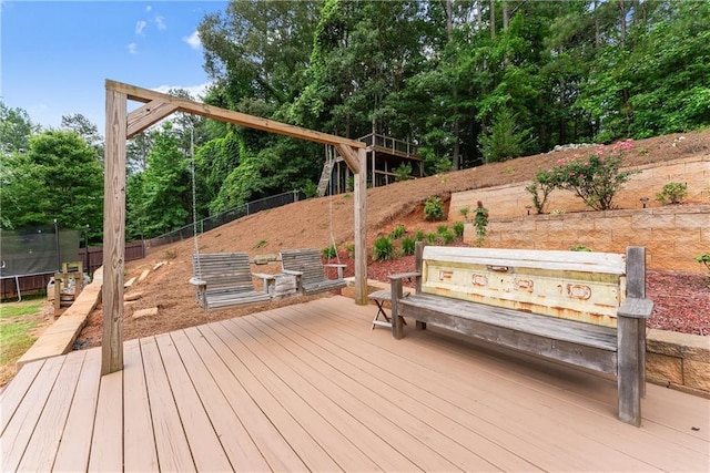 69 Maple Leaf Ct, Hoschton, GA 30548 - wooden deck with a trampoline and a fenced backyard