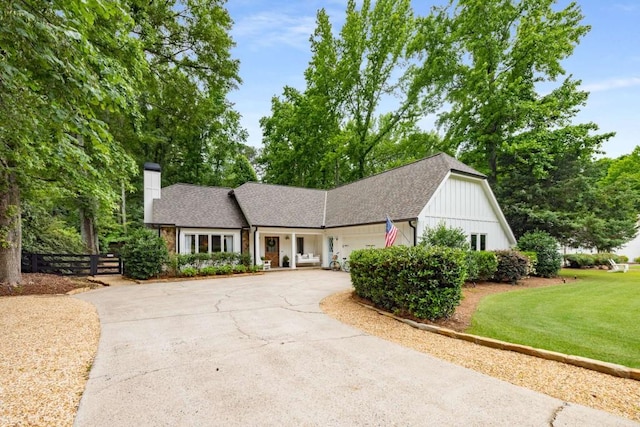 7114 Surrey Pt, Alpharetta, GA 30009 - view of front of home with concrete driveway, a chimney, an attached garage, and roof with shingles