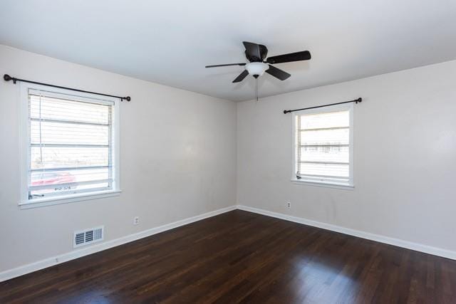 spare room with a ceiling fan, wood finished floors, baseboards, and visible vents