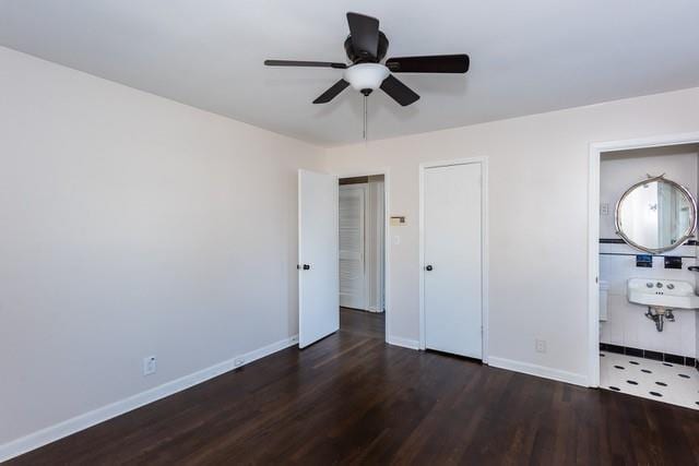 unfurnished bedroom featuring ceiling fan, baseboards, and wood finished floors