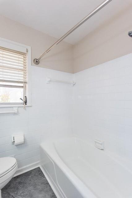 bathroom featuring bathing tub / shower combination and toilet