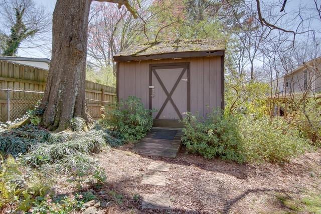 view of shed featuring fence