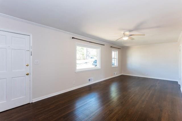 empty room featuring a ceiling fan, dark wood-style floors, baseboards, and ornamental molding