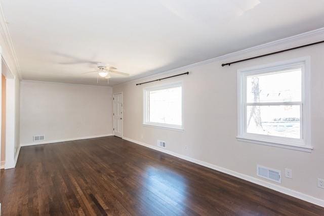 spare room with visible vents, baseboards, and dark wood-style floors