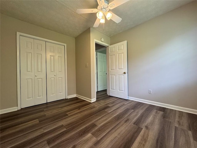 8170 Canyon Forge Dr, Riverdale, GA 30274 - unfurnished bedroom with dark wood finished floors, a textured ceiling, a closet, and a ceiling fan