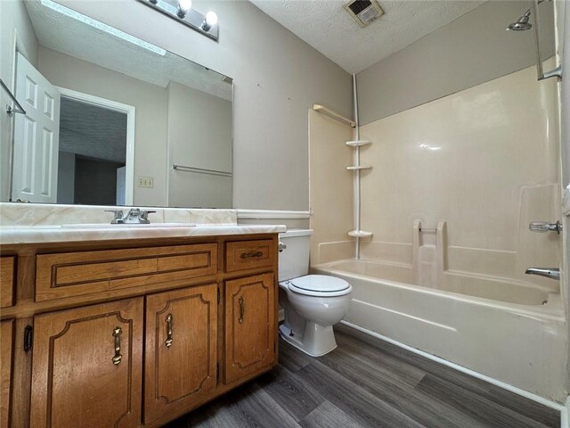 8170 Canyon Forge Dr, Riverdale, GA 30274 - bathroom featuring wood finished floors, bathtub / shower combination, a textured ceiling, and vanity