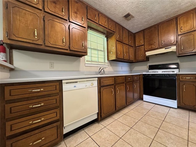8170 Canyon Forge Dr, Riverdale, GA 30274 - kitchen with dishwasher, range with gas cooktop, under cabinet range hood, light countertops, and light tile patterned floors