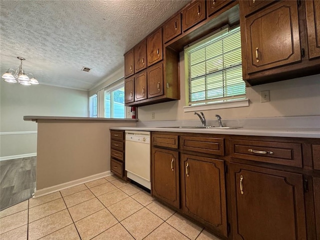 8170 Canyon Forge Dr, Riverdale, GA 30274 - kitchen with dishwasher, a textured ceiling, light countertops, a chandelier, and a peninsula