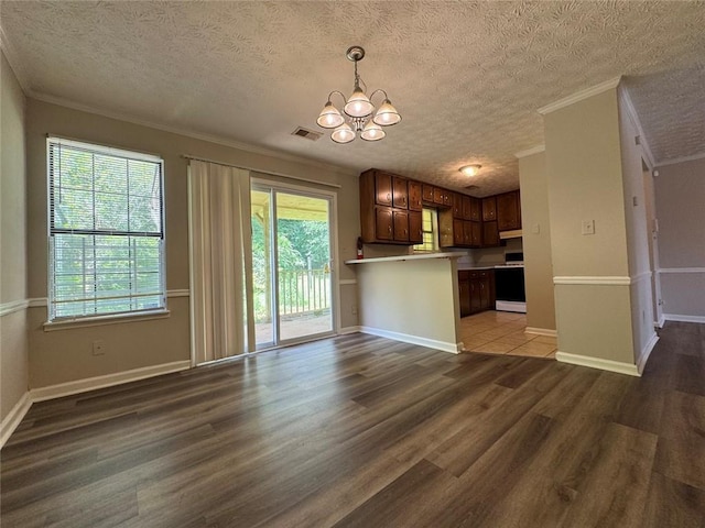 8170 Canyon Forge Dr, Riverdale, GA 30274 - kitchen featuring range, crown molding, a chandelier, wood finished floors, and healthy amount of natural light