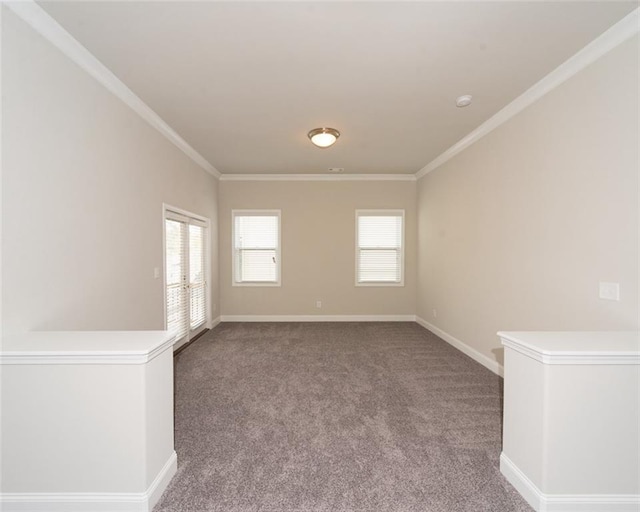 empty room with carpet floors, ornamental molding, and baseboards