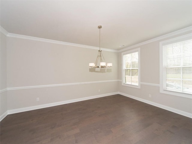 unfurnished room featuring dark wood-style floors, crown molding, baseboards, and an inviting chandelier